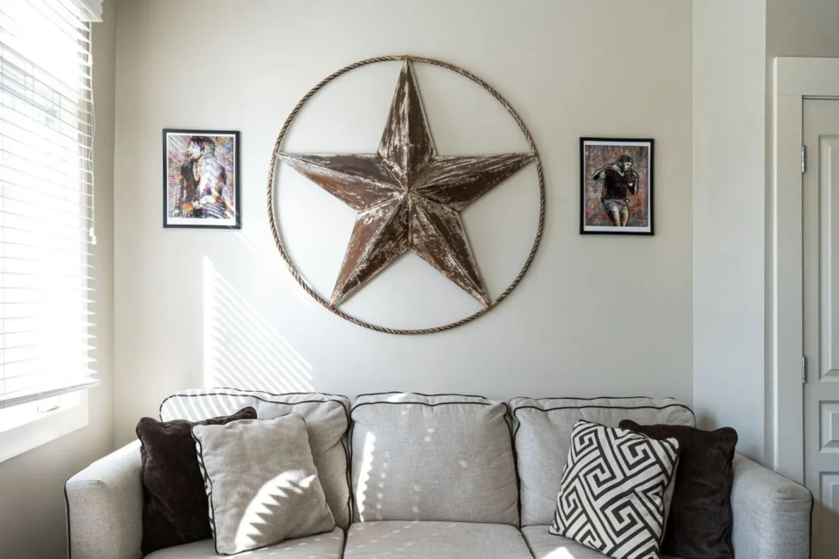 A bright, comfortable living area featuring a sofa, a large star decoration, and framed artwork. Sunlight streams in, creating an inviting atmosphere ideal for relaxing, reading, or working remotely.